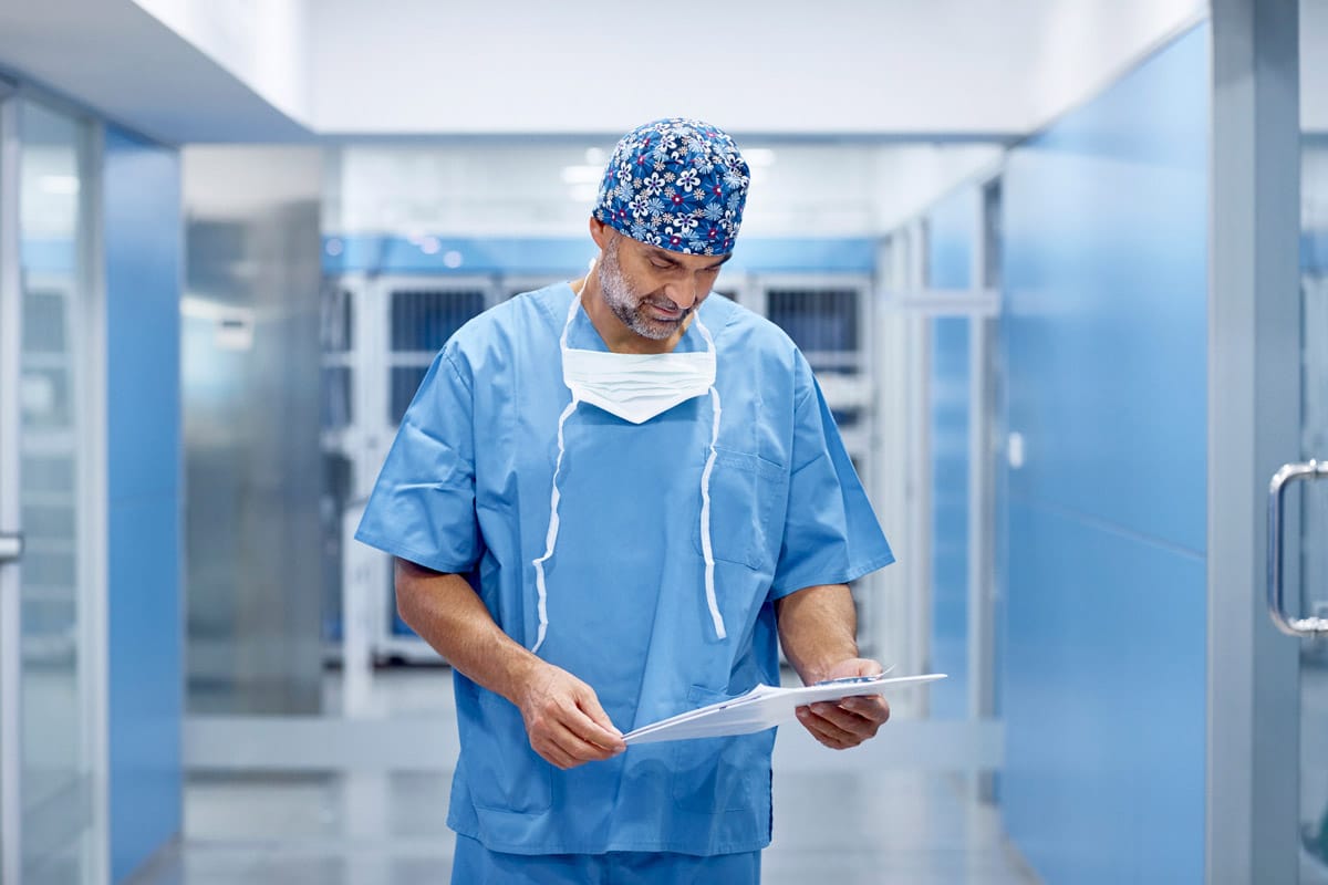Photo of male veterinarian with chart representative of Independent Veterinary Practices.